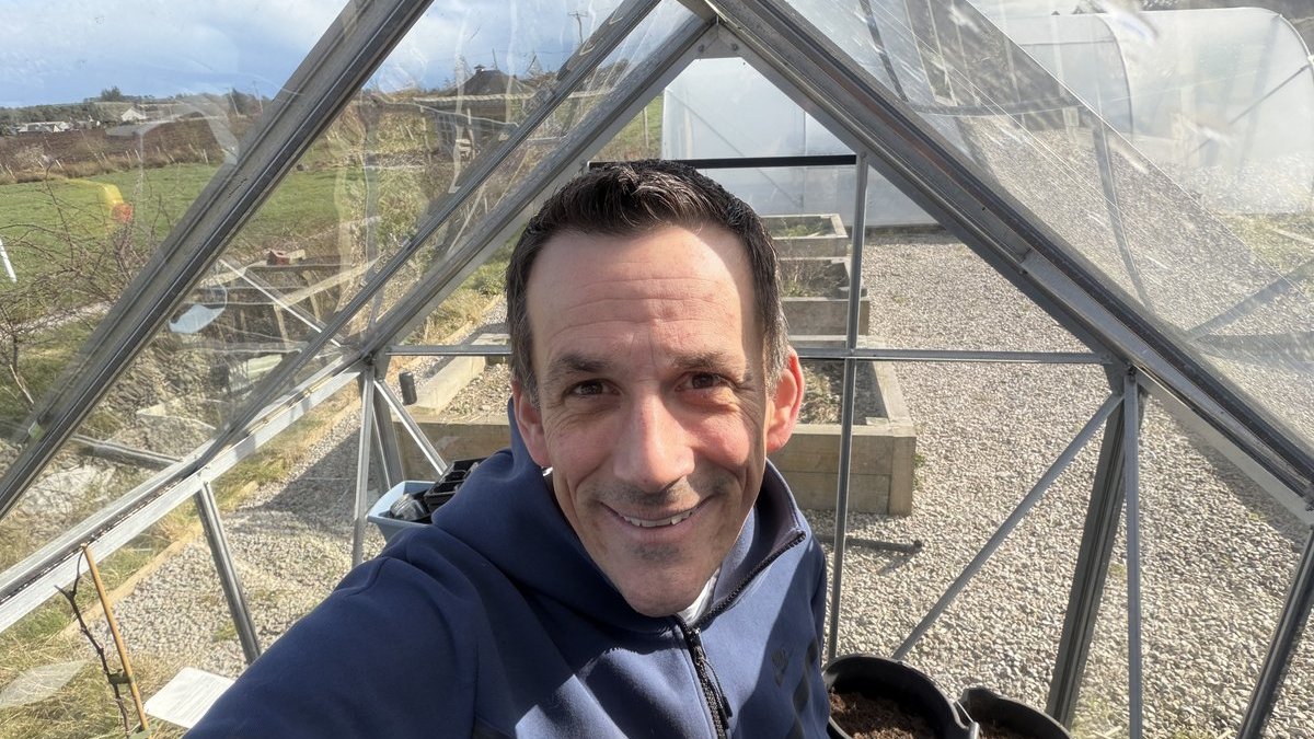 Damo in the greenhouse on the first tidy-up day of spring